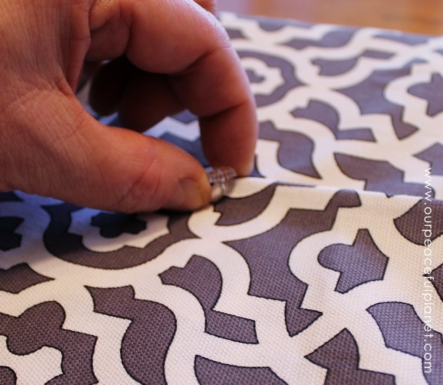 Upholstery pins are are an incredibly simple yet versatile tool for doing some quick no-sew recovering in your home. We recovered a window seat in minutes!