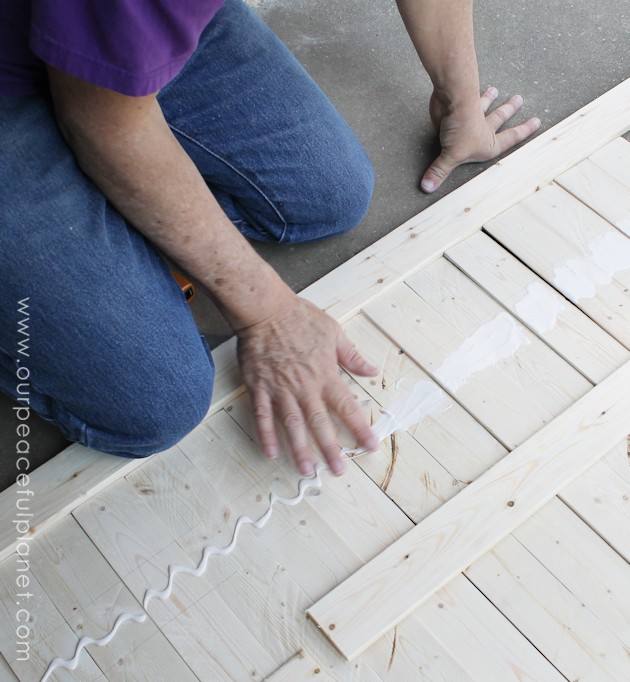 Add some whimsy to your home with this easy DIY picket fence fireplace cover. Made with wood slats and some hinges you can decorate it for any season. 