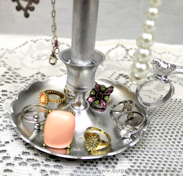 Make this beautiful, classy jewelry stand from something you can find at almost any thrift store... an old fashioned candle holder! Just add dowels & paint!