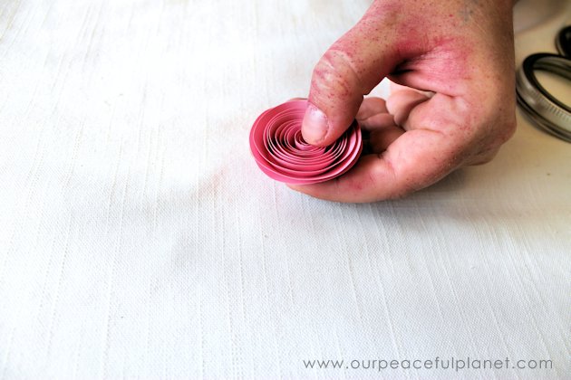Make these beautiful DIY paper flowers in 5 minutes or less! Use them in your crafts or decorating. Attach them to a lamp shade. Even use them in your hair!