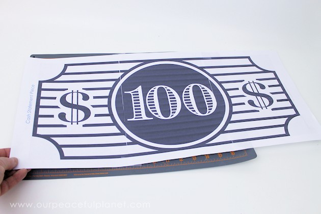 We made this classy $100 bill statement piece out of a piece of foam board used as packing in something we ordered. Cost? $0 (You can also buy foam cheap!)