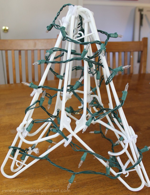 We'll show you how to make the prettiest little rustic upcycled burlap Christmas tree you've ever seen using six hangers. Add bells & a star to complete it.