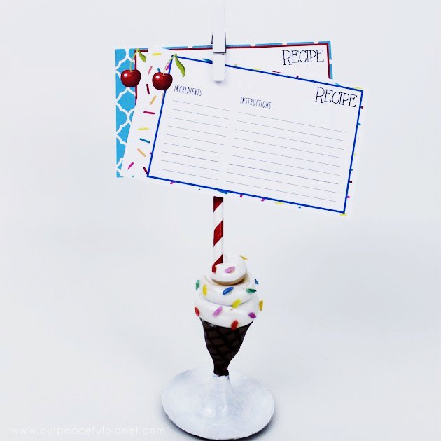 This fun portable recipe holder is made from an old brass candle stick holder and some clay! It's super easy and we've got free matching recipe cards also!