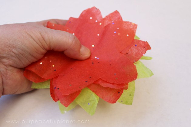 We'll show you how to make these inexpensive and beautiful poinsettia lights using normal LED twinkle lights, red and green tissue paper, and floral tape.