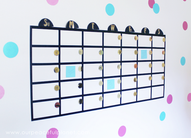Get organized with this fun huge wall calendar made with Washi tape, large sequins and Post-it notes! It's great for a home offices or a family center!