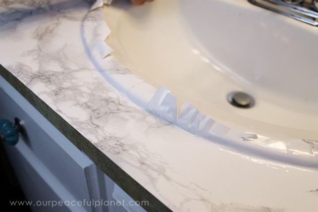 Transform your bathroom for only a few dollars with a contact paper countertop. You'll be amazed at how beautiful it looks & so will your family & guests!