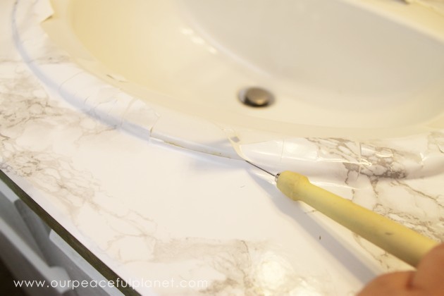 Transform your bathroom for only a few dollars with a contact paper countertop. You'll be amazed at how beautiful it looks & so will your family & guests!