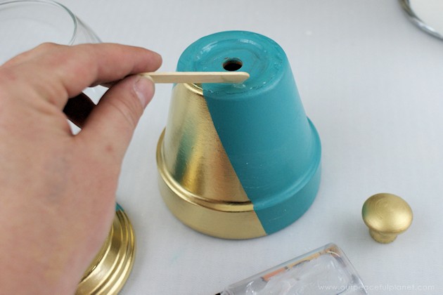 A beautiful gold & teal version of the classic DIY gumball machine, made from a clay pot & a glass bowl. Use it for gum, candy or a variety of other things!