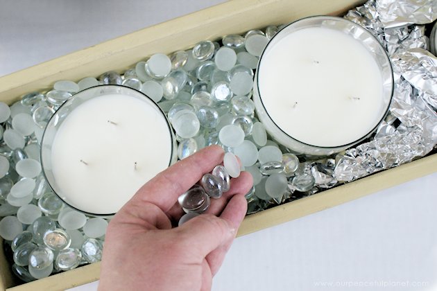 This DIY table centerpiece allows you to change decor year round for any occasion. Then lift out the pegboard insert to find candles for ambient lighting!
