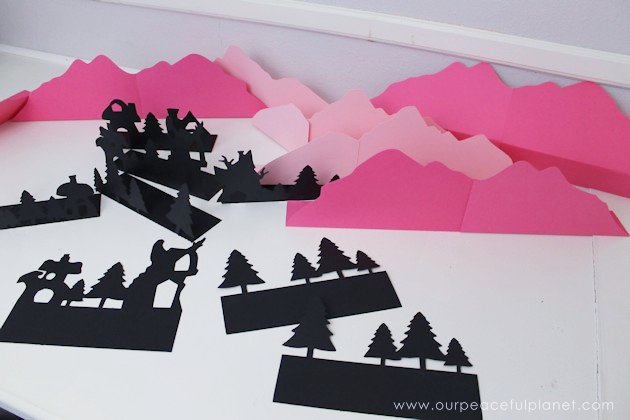  Grab the free printables and make these unique and inexpensive paper town shelf sitters! They will add a bit of whimsy to any room and only cost pennies.