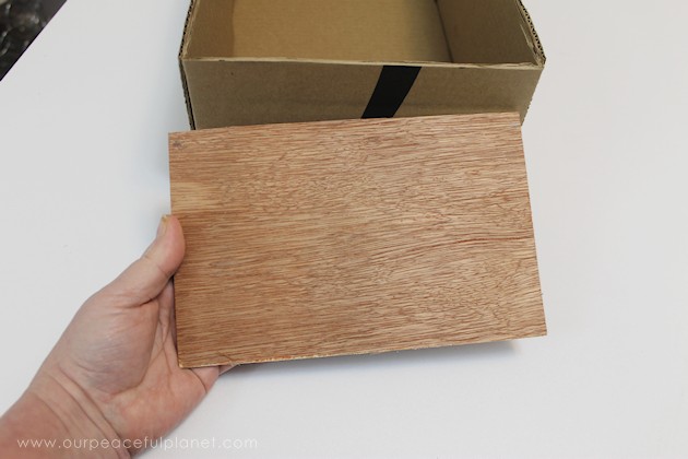 Learn how to make an inexpensive pull out cabinet organizer using a cardboard box so you can easily access things in the far reaches of your lower cabinets.